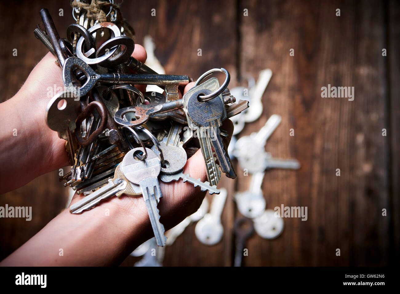 Hands holding an old metal keys Stock Photo Alamy