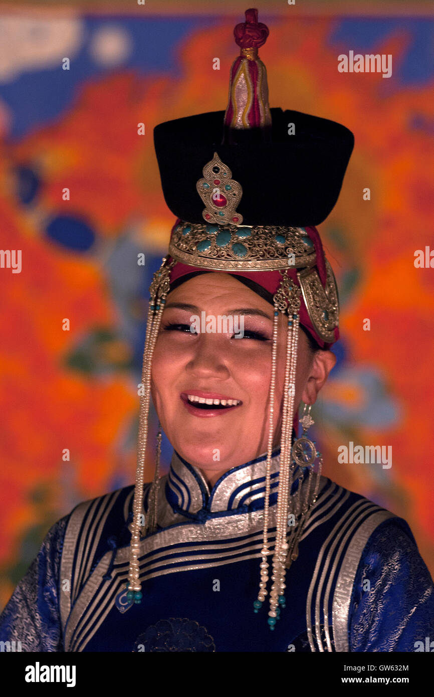 A dancer dressed in typical Mongolian dresses performs in a traditional show Stock Photo