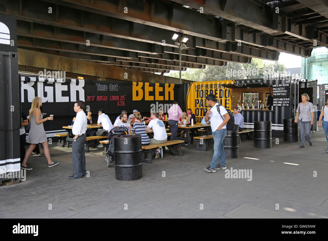 A pop-up container bar under Hungerford Railway Bridge on London's South Bank, next to the River Thames Stock Photo