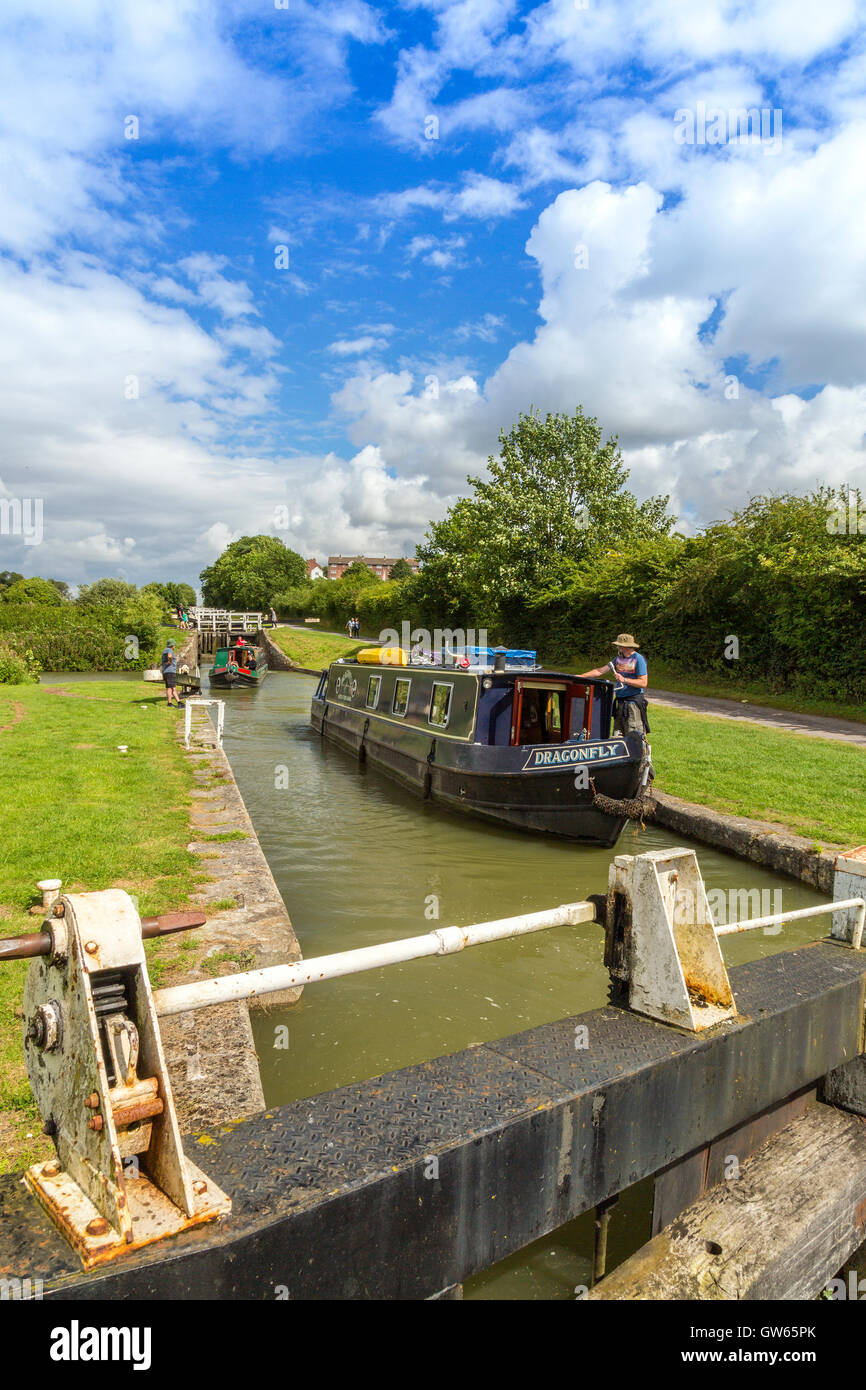 Colourful barges entering one of the 16 Caen Hill locks on the Kennet & Avon Canal nr Devizes, Wiltshire, England, UK Stock Photo