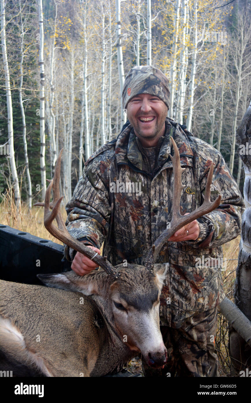 smiling hunter shows his large public land utah mule deer Stock Photo