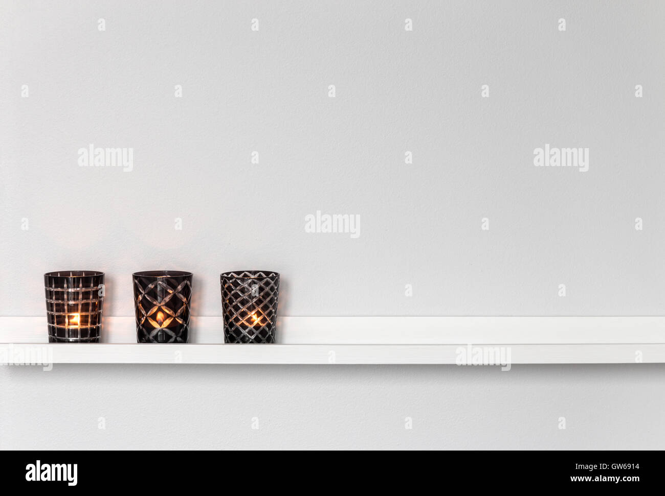 Candle lights on white shelf Stock Photo Alamy