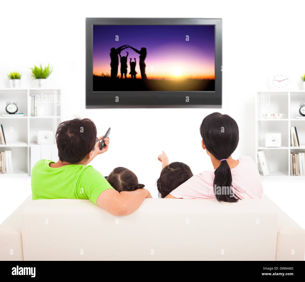 family watching the tv in living room Stock Photo Alamy