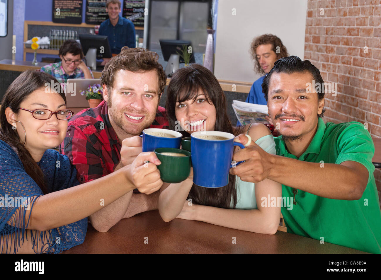 Joyful Group Holding Mugs Stock Photo Alamy