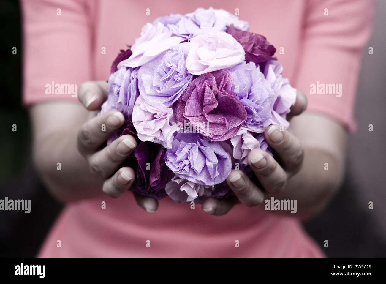 The girl in a pink dress holding a bouquet of purple flowers Stock ...