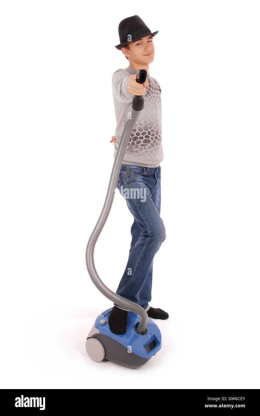 Boy in a hat holding a vacuum cleaner isolated on white background