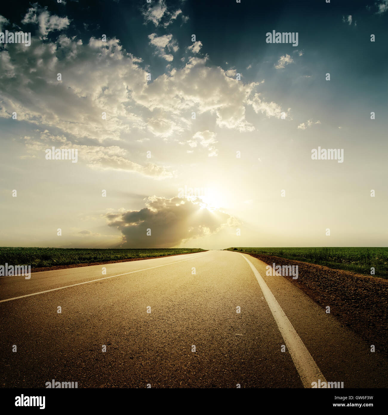 dramatic sunset over road to horison Stock Photo
