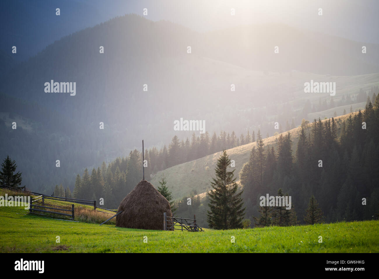 Amazing mountain landscape with a haystack Stock Photo - Alamy