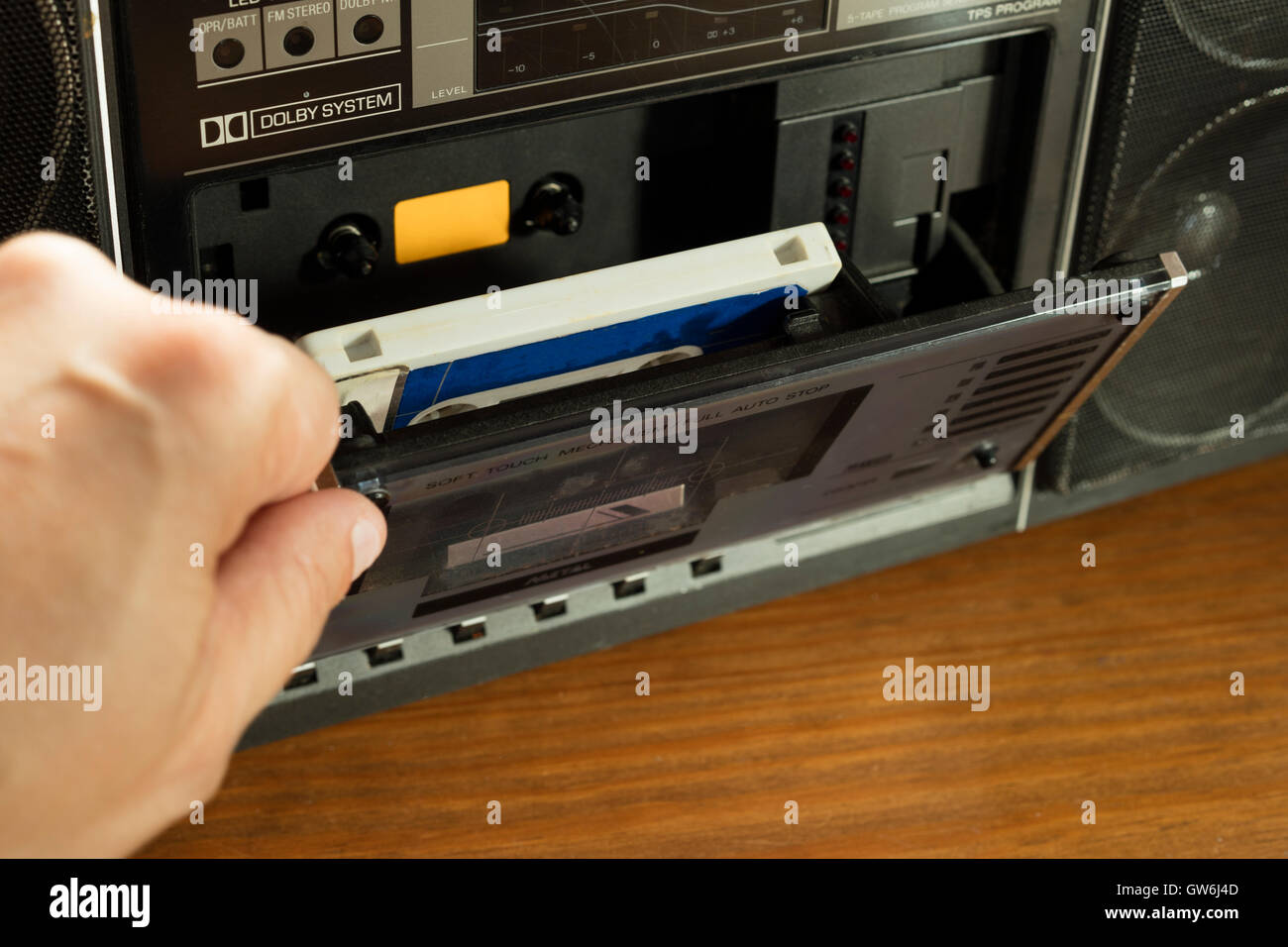 Vintage cassette player with tape inside on a wooden table Stock Photo