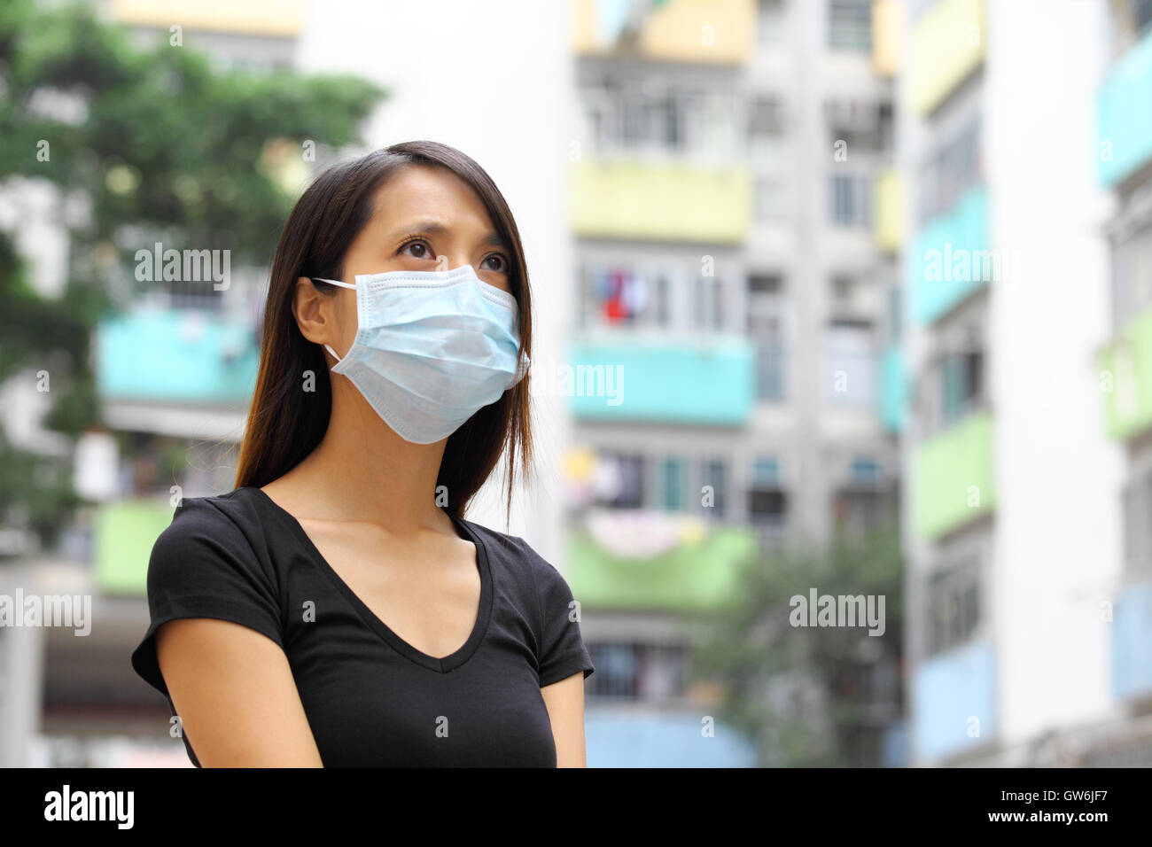 Woman wearing medical face mask in crowded city Stock Photo - Alamy