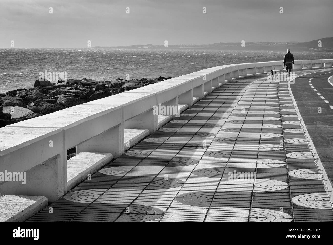 A man walking a dog in Las Palmas de Gran Canaria, Spain Stock Photo