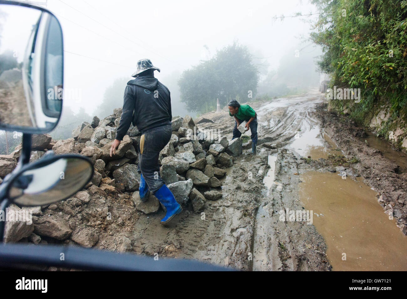 Clearing the road by hand on the road between Bumthang and Trongsa. Stock Photo