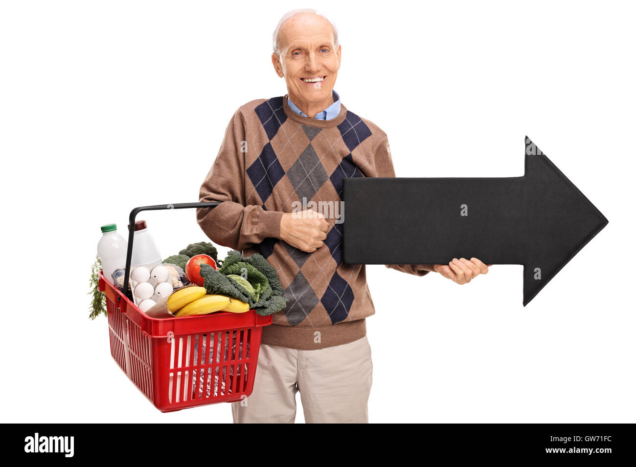 Elderly man holding a shopping basket and an arrow pointing right isolated on white background Stock Photo