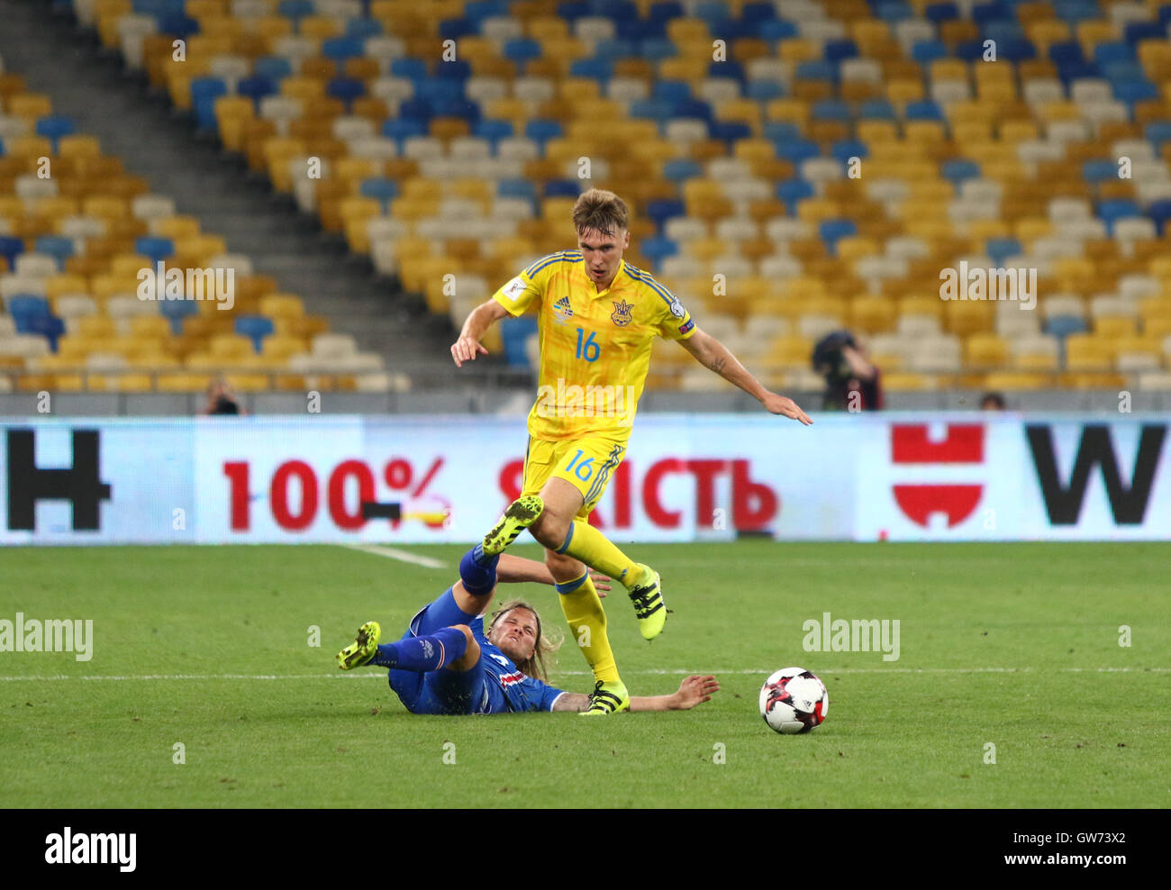 Serhiy Sydorchuk of Ukraine (in Yellow) fights for a ball with Birkir