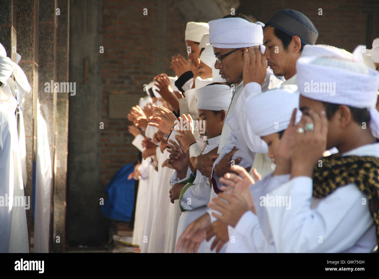 Medan, North Sumatra, Indonesia. 12th Sep, 2016. NORTH SUMATRA, INDONESIA - SEPTEMBER 12 : Indonesia muslim pray during the celebration of Eid al-Adha at Al-Mudziri islamic boarding school on September 12, 2016 in Medan, North Sumatra Province, Indonesia. Muslims worldwide celebrate Eid Al-Adha, to commemorate the holy Prophet Ibrahim's (Prophet Abraham) readiness to sacrifice his son as a sign of his obedience to God, during which they sacrifice permissible animals, generally goats, sheep, and cows. Eid-al Adha is the one of two most important holidays in the Islamic calendar, with pray Stock Photo