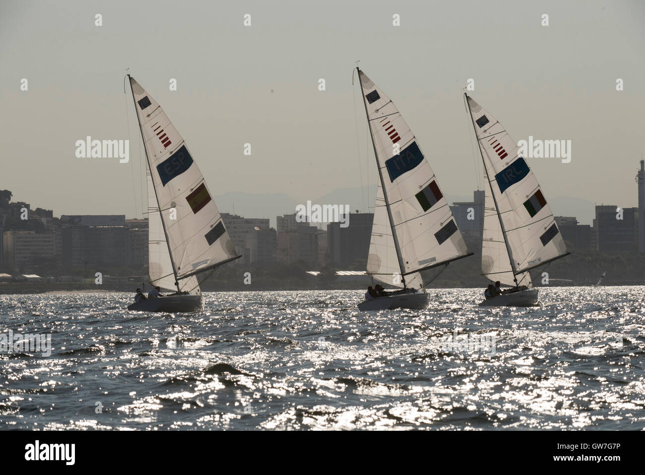 The 3-person keelboat Sonar class boats race on Guanabara Bay during sailing competition at  the 2016 Paralympics. Stock Photo
