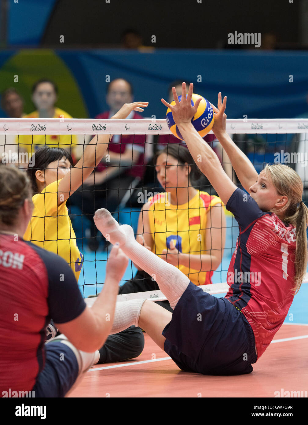 Lora Webster of the USA blocks a spike from a Chinese player in a women's sitting volleyball match at the Paralympic Games. Stock Photo
