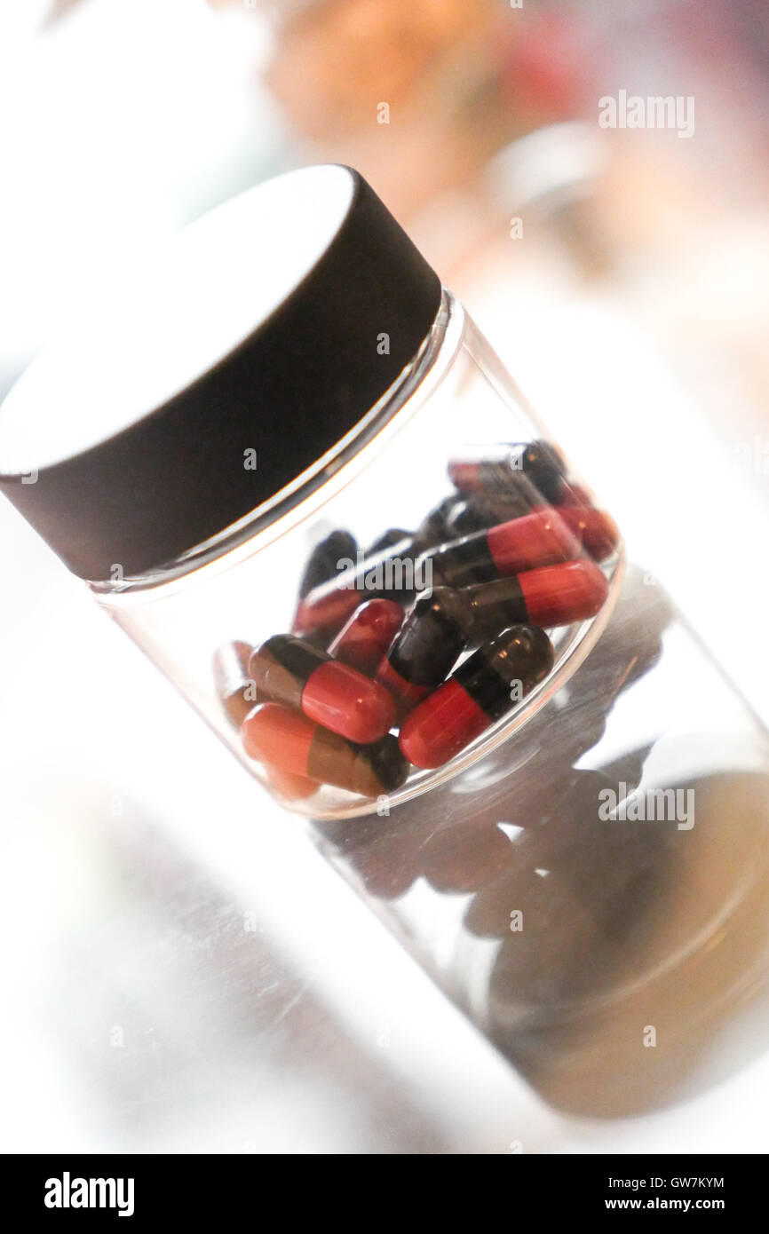 Medicine pills or capsules in box on a table Stock Photo