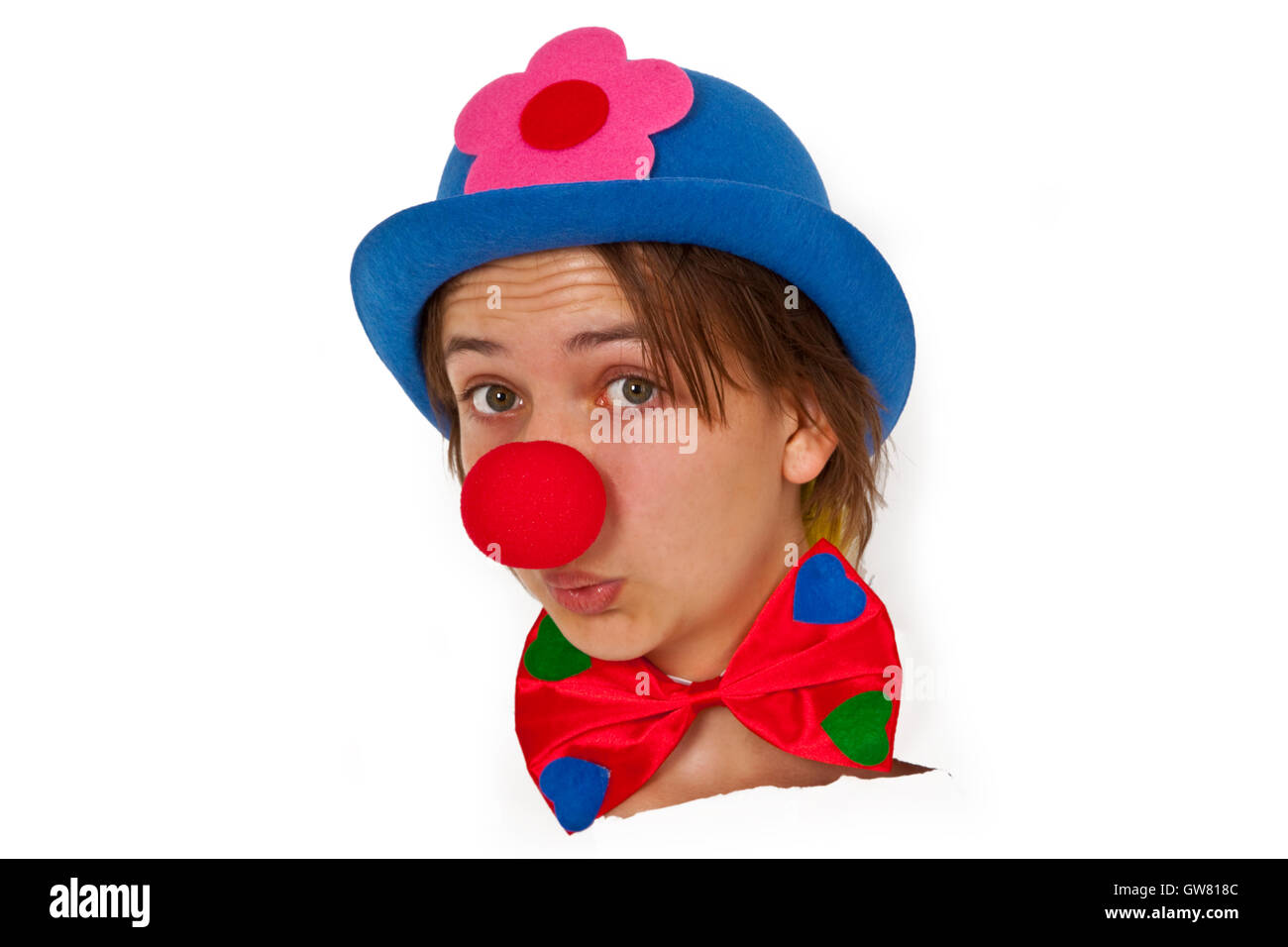 Clown with red nose looking out of white paper Stock Photo