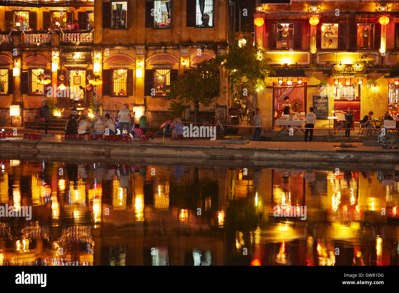 Restaurants reflected in Thu Bon River at dusk, Hoi An (UNESCO World Heritage Site), Vietnam Stock Photo