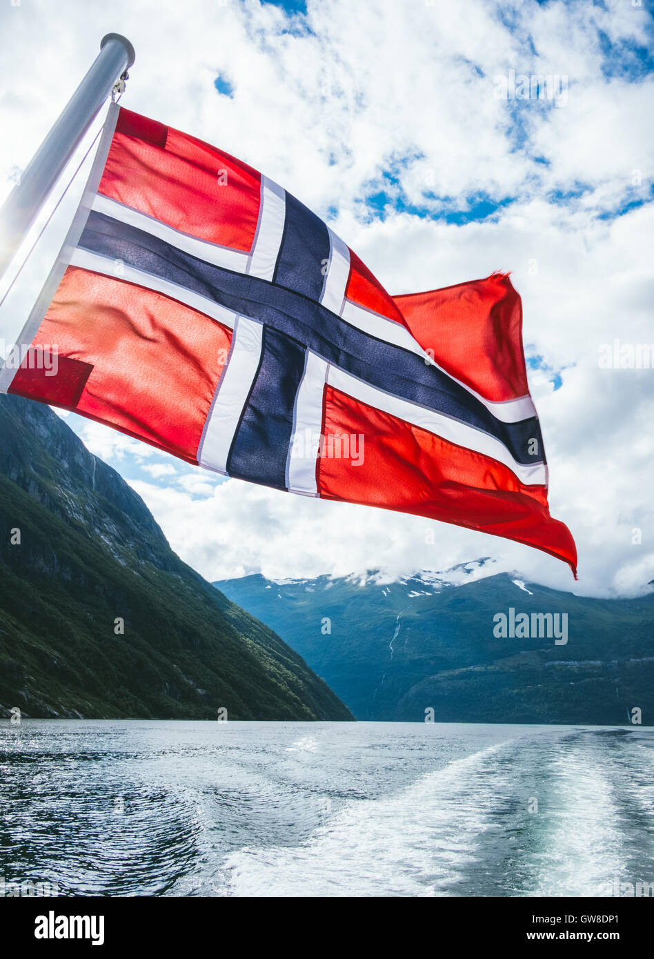 Norwegian flag on a passenger ferry , Geiranger fjord, Norway Stock Photo