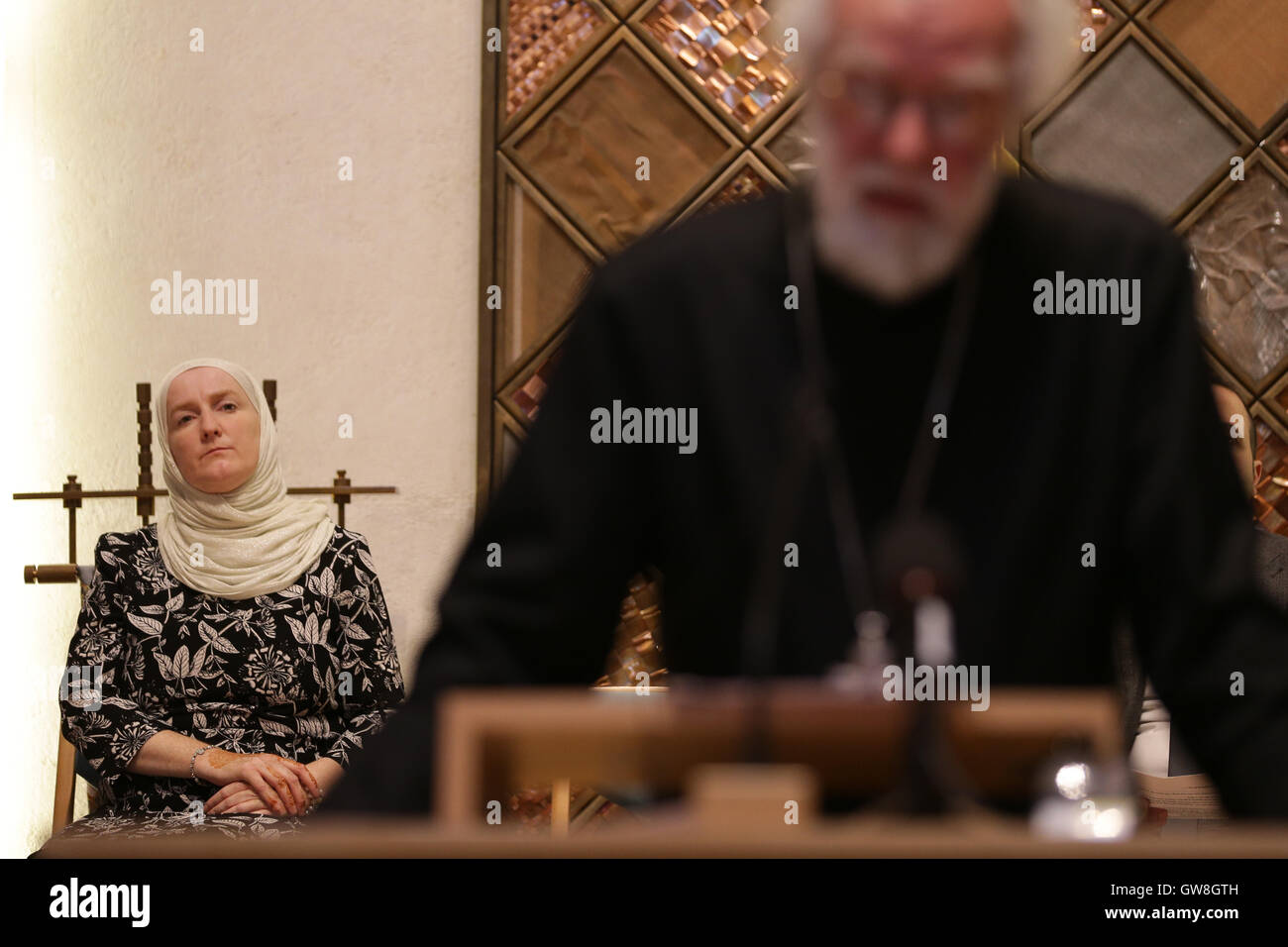 Julie Siddiqi, former director of the Islamic Society of Britain, watches Dr Rowan Williams, former Archbishop of Canterbury, address an event calling on the Prime Minister to do more to help refugees, at the Liberal Jewish Synagogue, London. Stock Photo