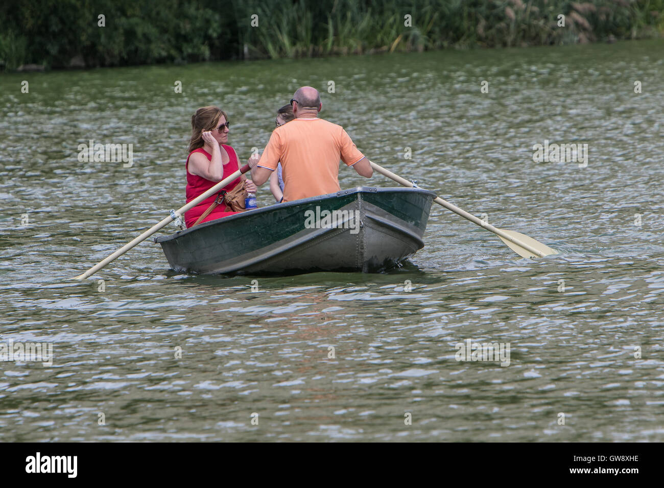 A family is boating in Central Park. Stock Photo