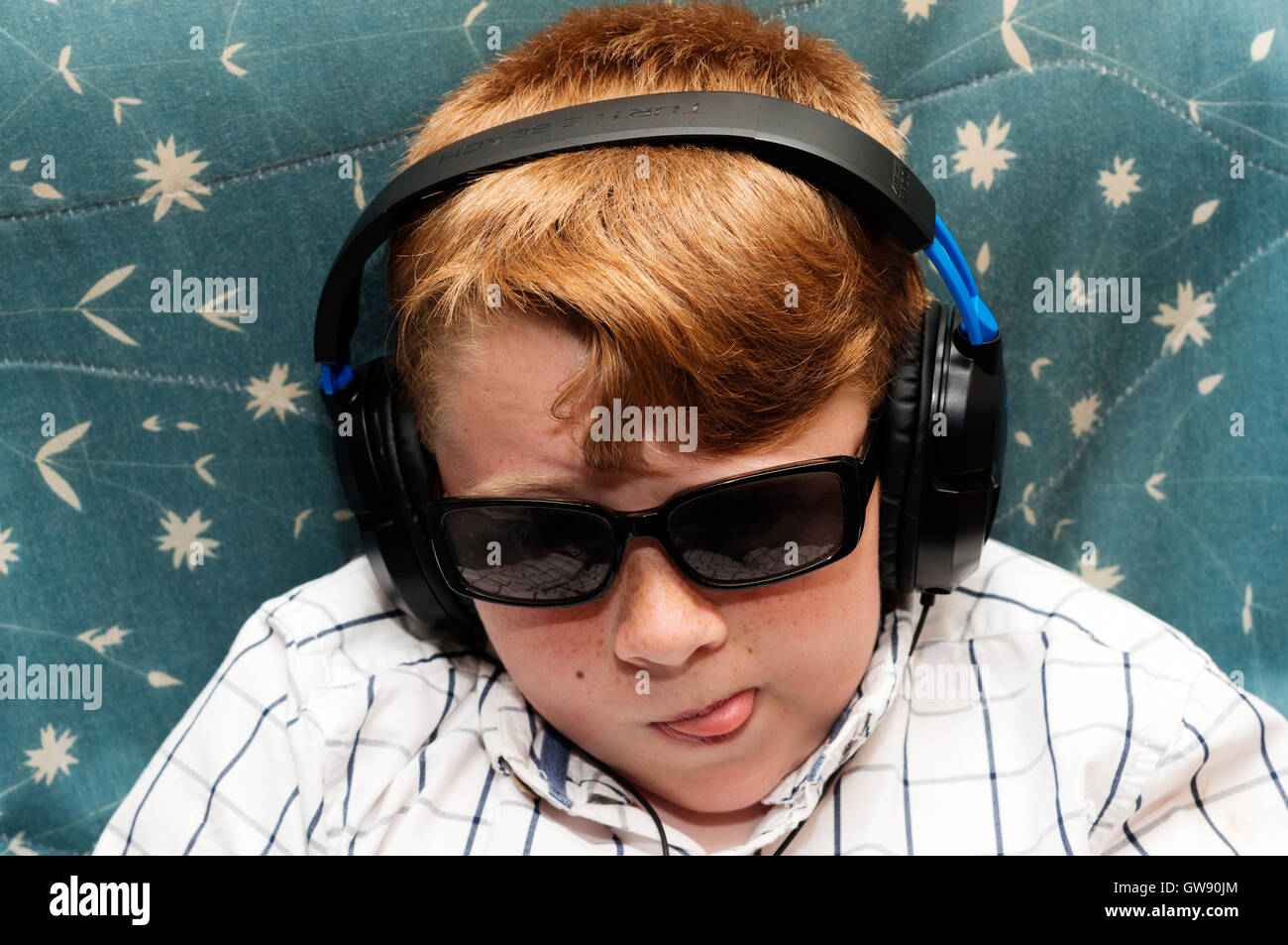 10-year old boy wearing headphones Stock Photo