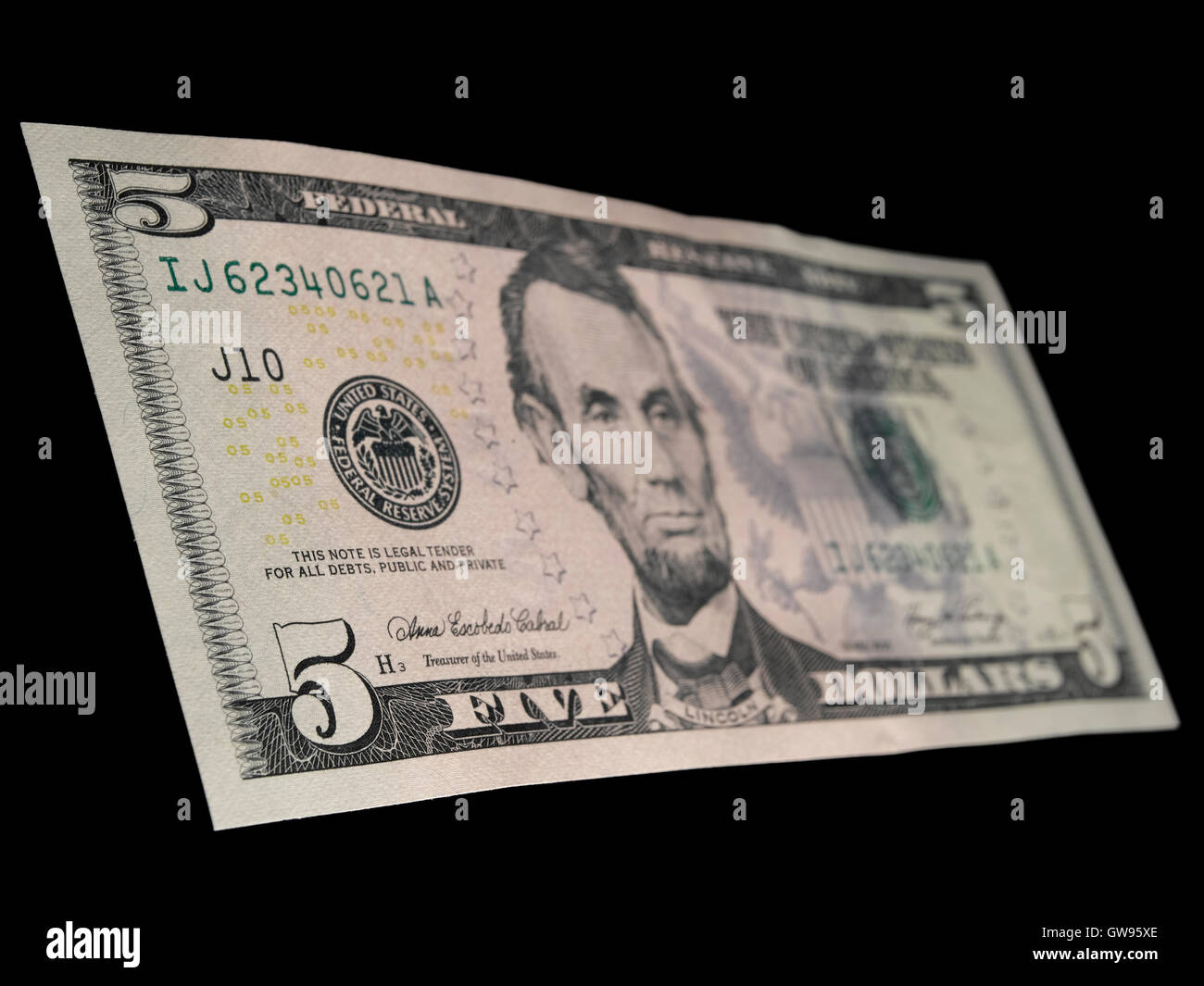 5 Dollar bill isolated on a black background Stock Photo