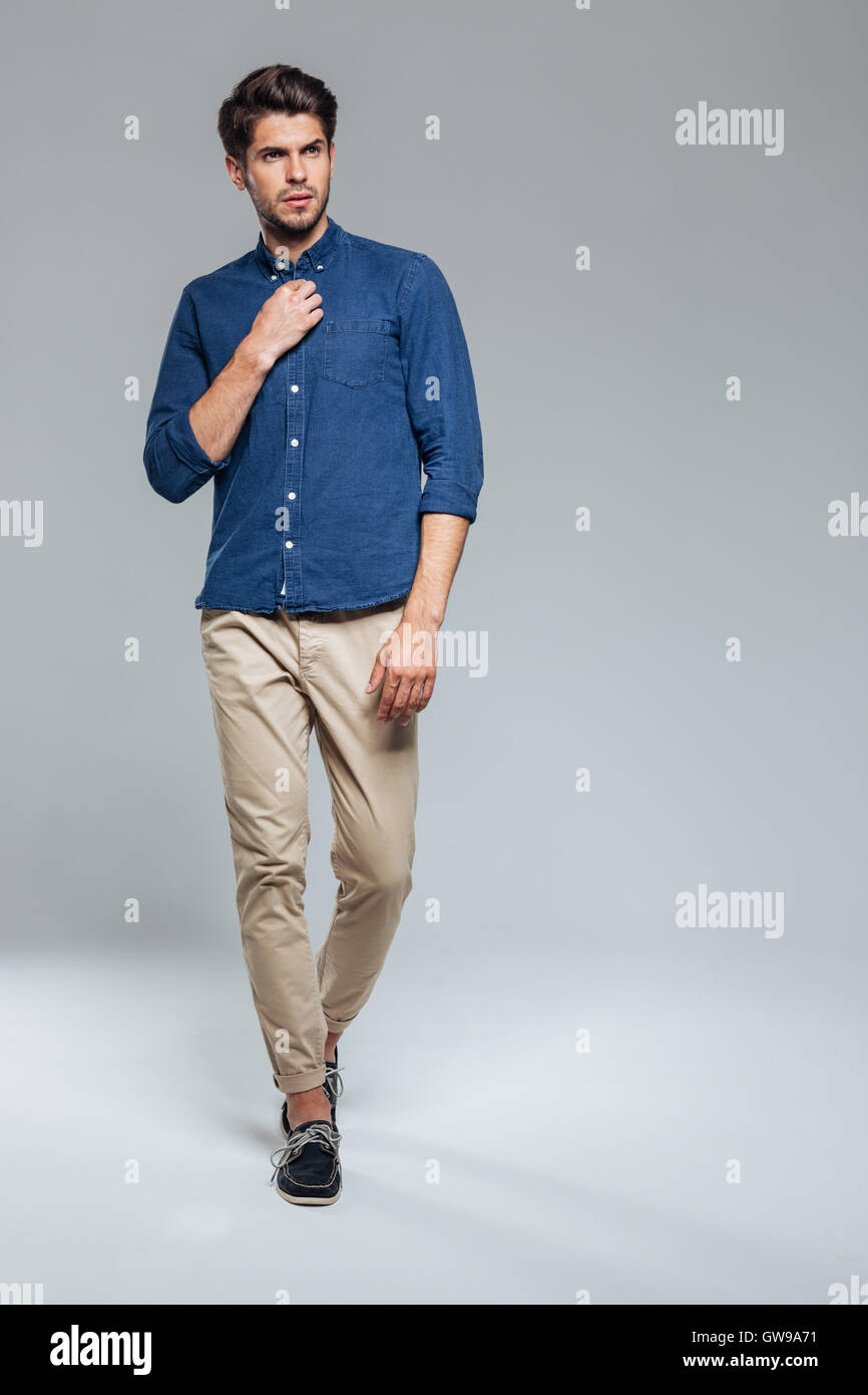 Full length portrait of a handsome young man standing isolated on the ...