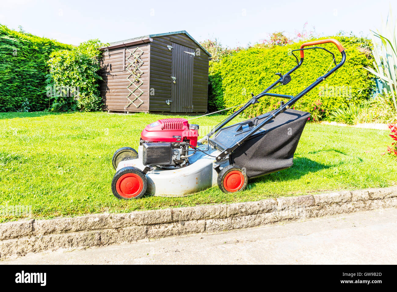 lawnmower grass cutting machine grass cutter gardening gardeners tool UK England GB Stock Photo