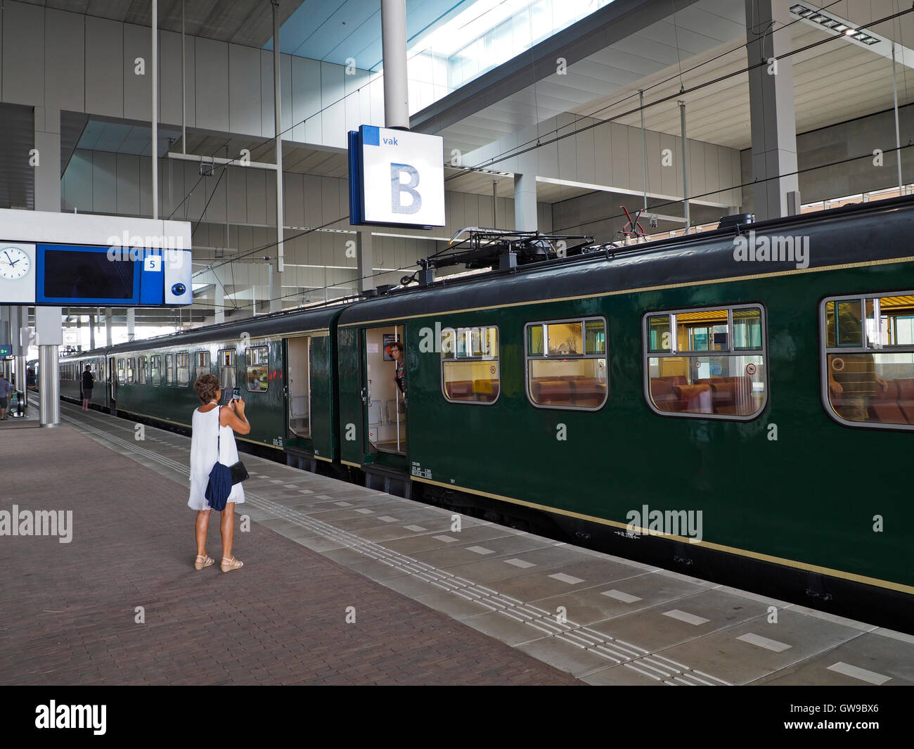 Woman photographing her friend in antique museum train, Breda Central Station, the Netherlands Stock Photo