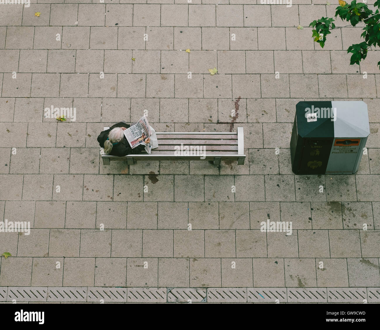 Reading newspaper on a bench hi-res stock photography and images - Alamy