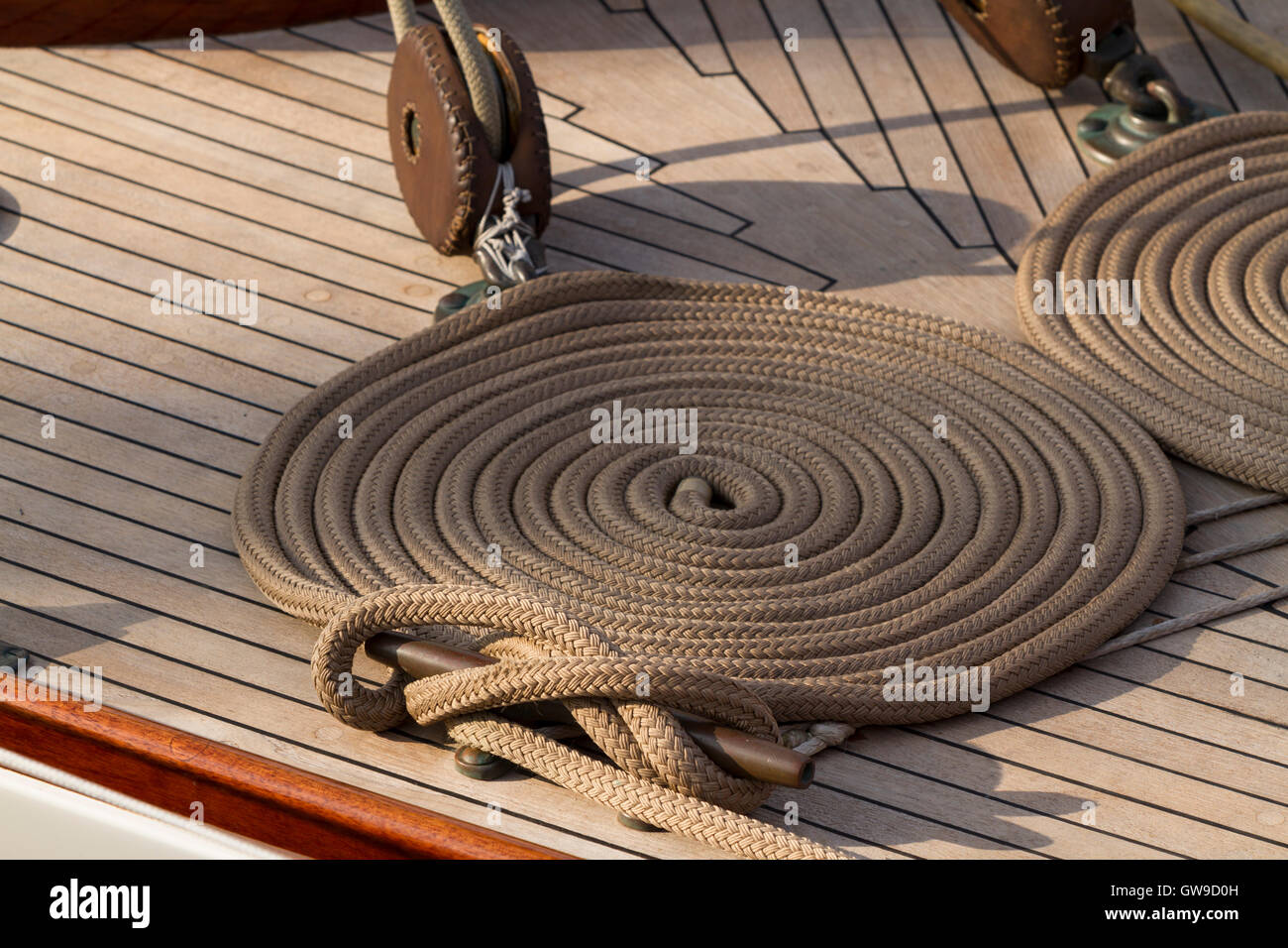 Coiled line and cleat on the deck of on 1938 classic sailing yacht 'Serenade' Stock Photo