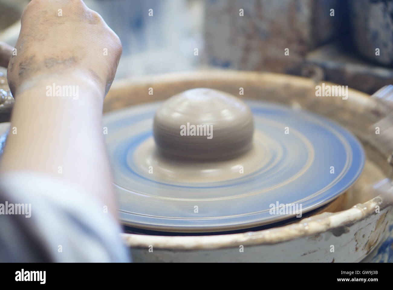 A pottery class, taken as pot is being thrown Stock Photo
