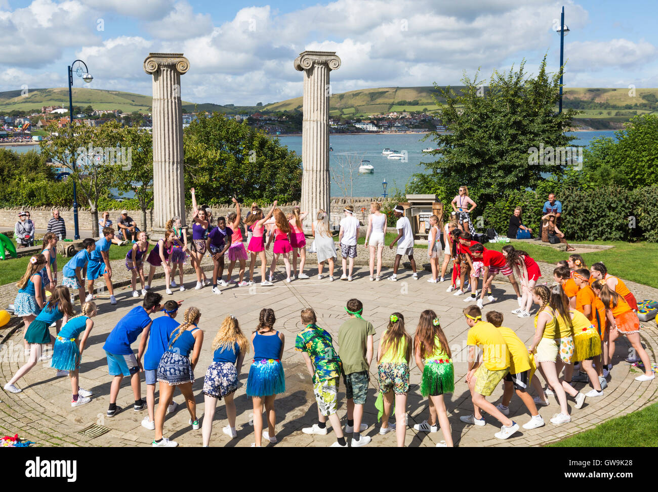 Youths of Horizon Community College dance as part of Swanage Folk Festival at Prince Albert Gardens, Swanage, Dorset UK in September Stock Photo
