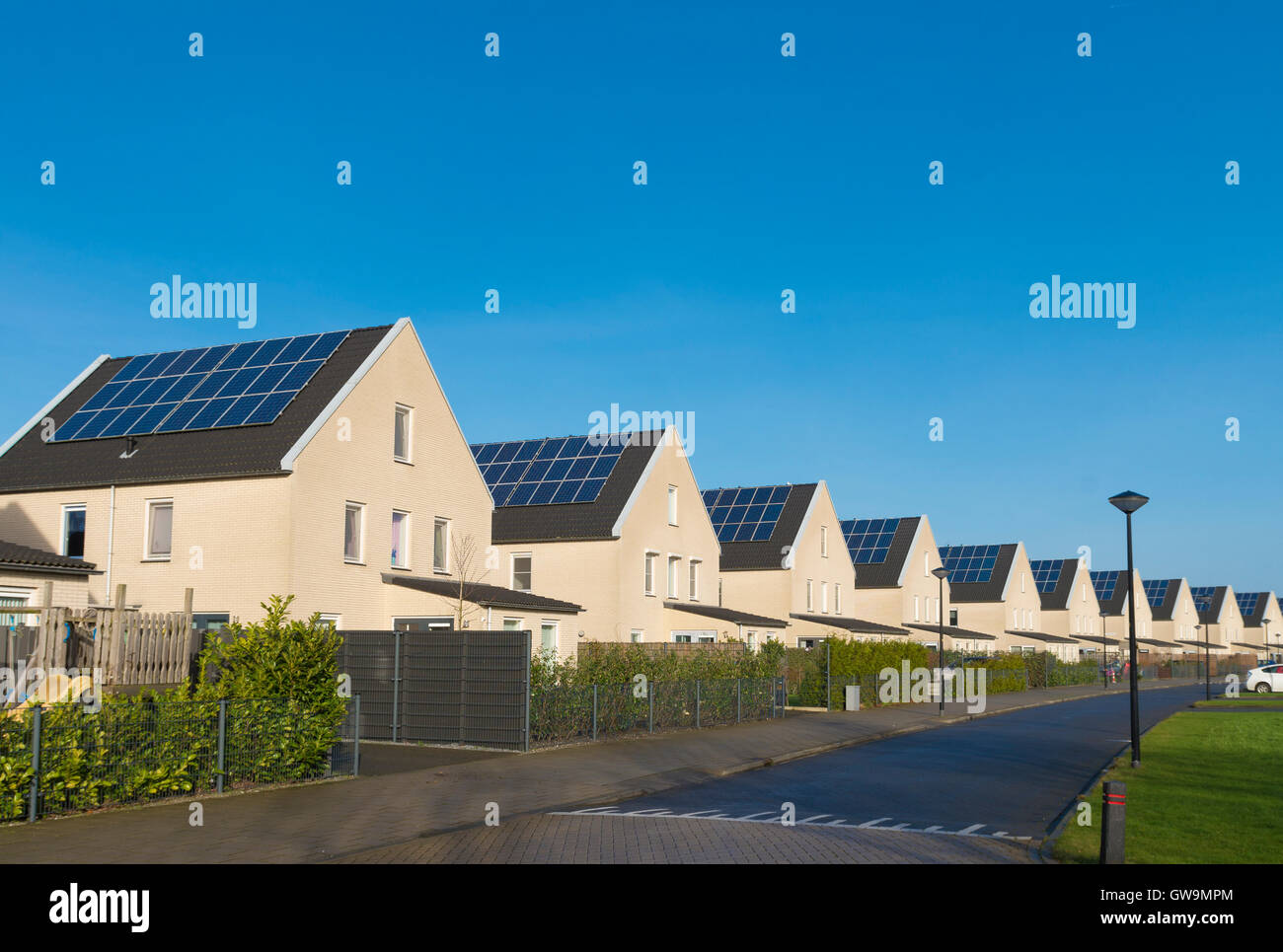row of newly build houses with solar panels in the netherlands Stock