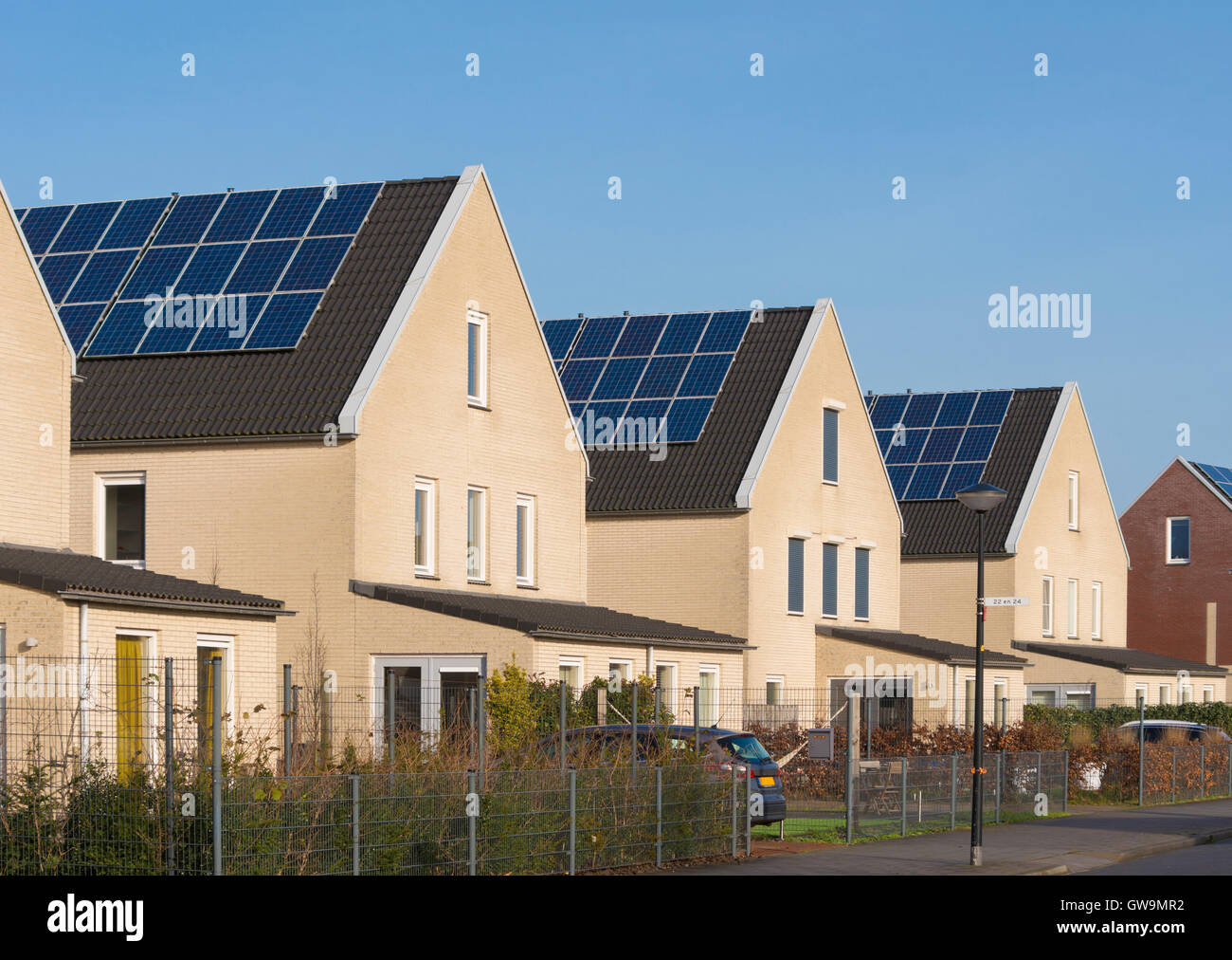 row of newly build houses with solar panels in the netherlands Stock