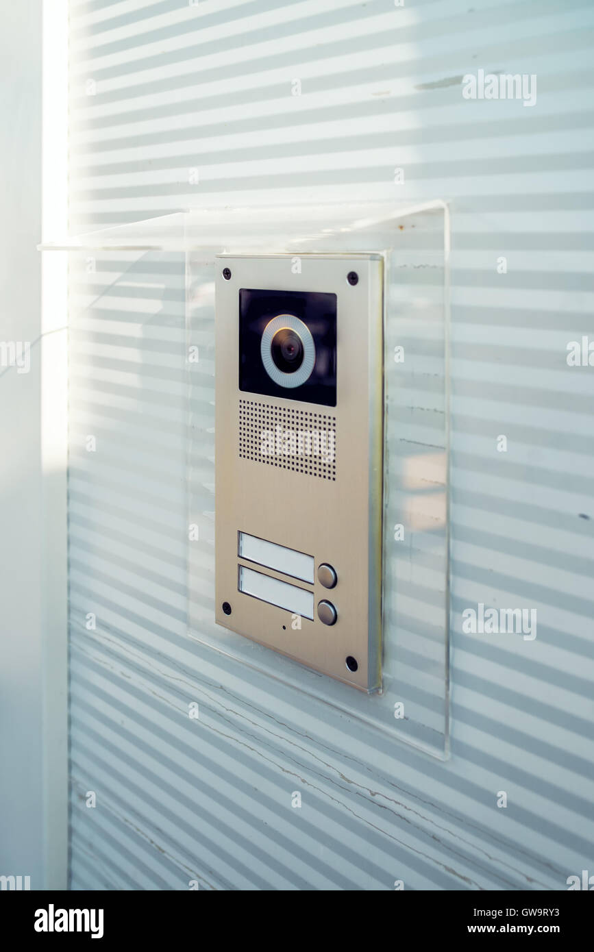 Video intercom device on building exterior wall for house entry and communication Stock Photo