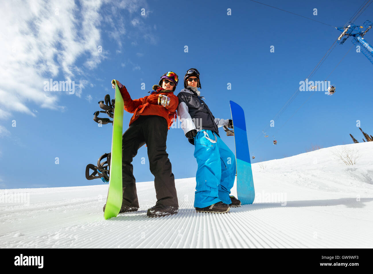 Group friends snowboarders snowboarding slope mountain Stock Photo