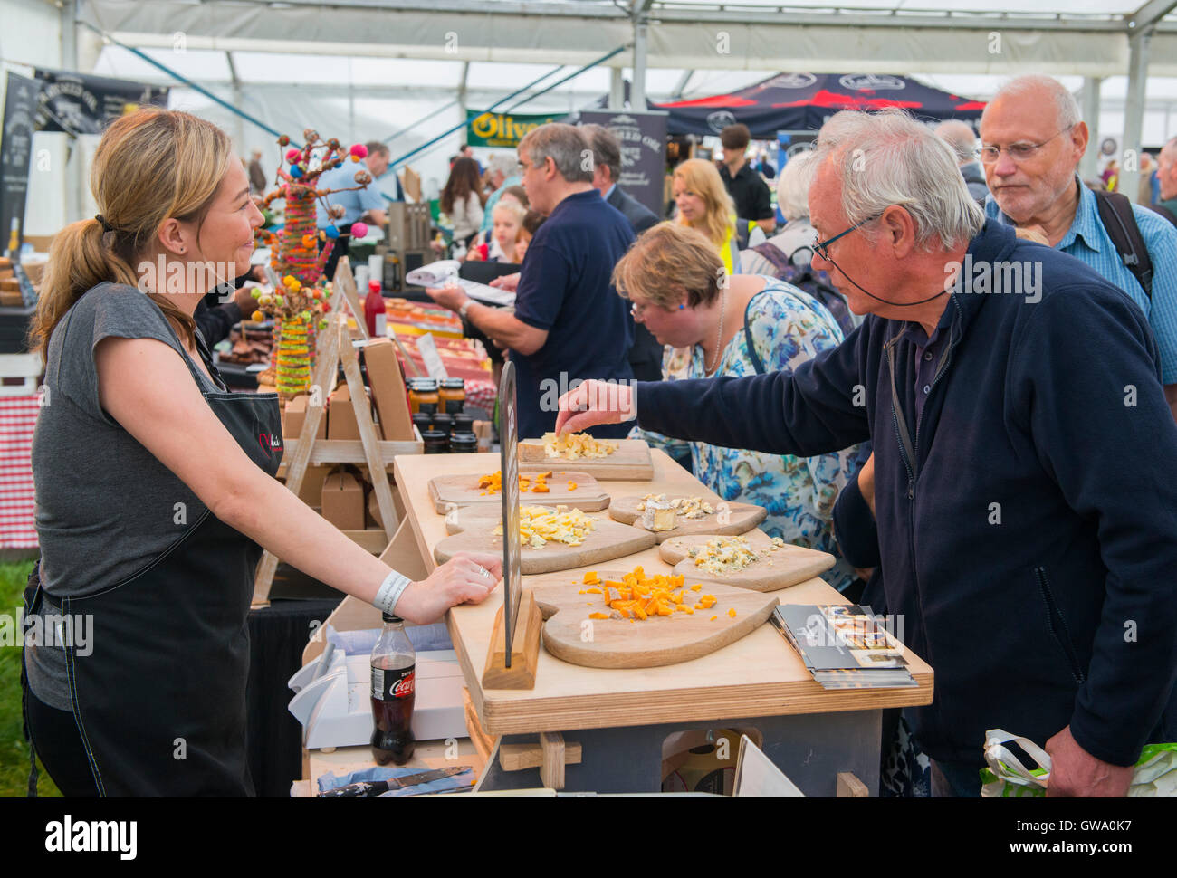 Visitors sampling cheese at Ludlow Food Festival, Shropshire, England