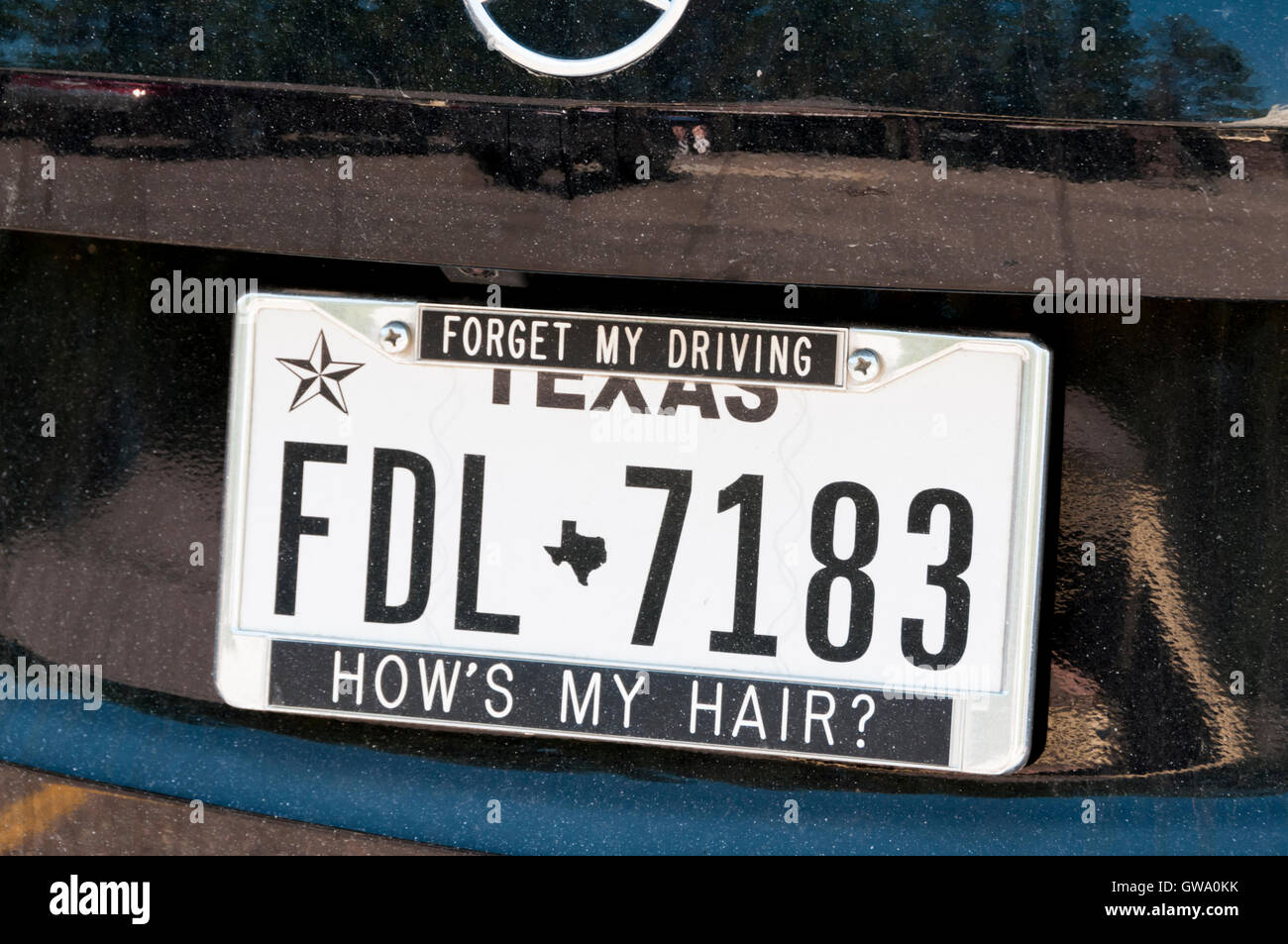 A humorous message on a Texas number plate reading Forget My Driving, How's My Hair? Stock Photo
