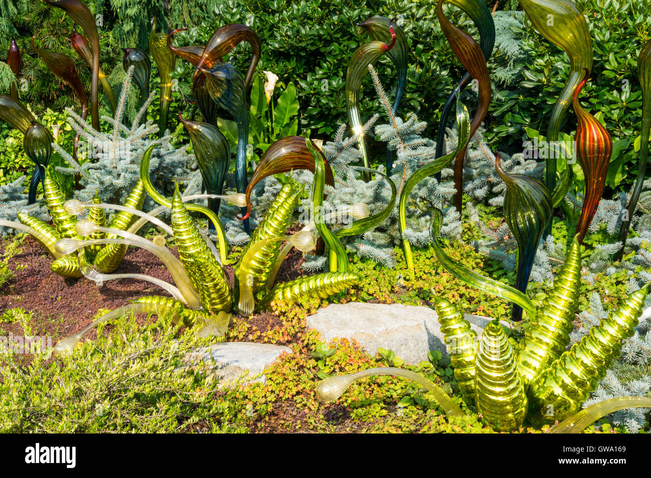A flower border containing blown glass decorations in the garden of
