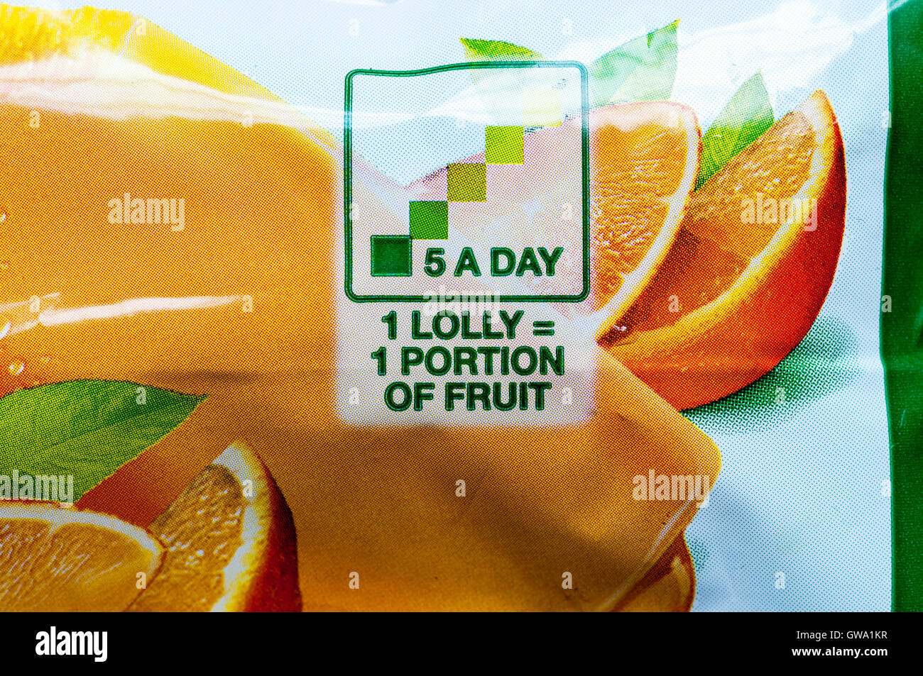 Wrapper of a Del Monte orange lolly says that 1 lolly equals 1 portion of fruit and is one of your 5 a day. Stock Photo