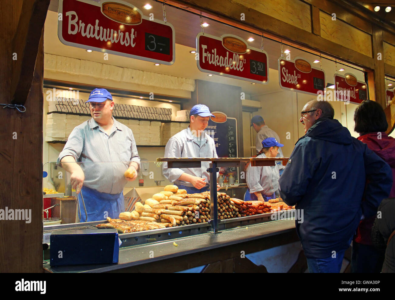 People buy sausages at traditional Christmas market on Potsdamer Platz on November 8, 2013 in Berlin, Germany Stock Photo