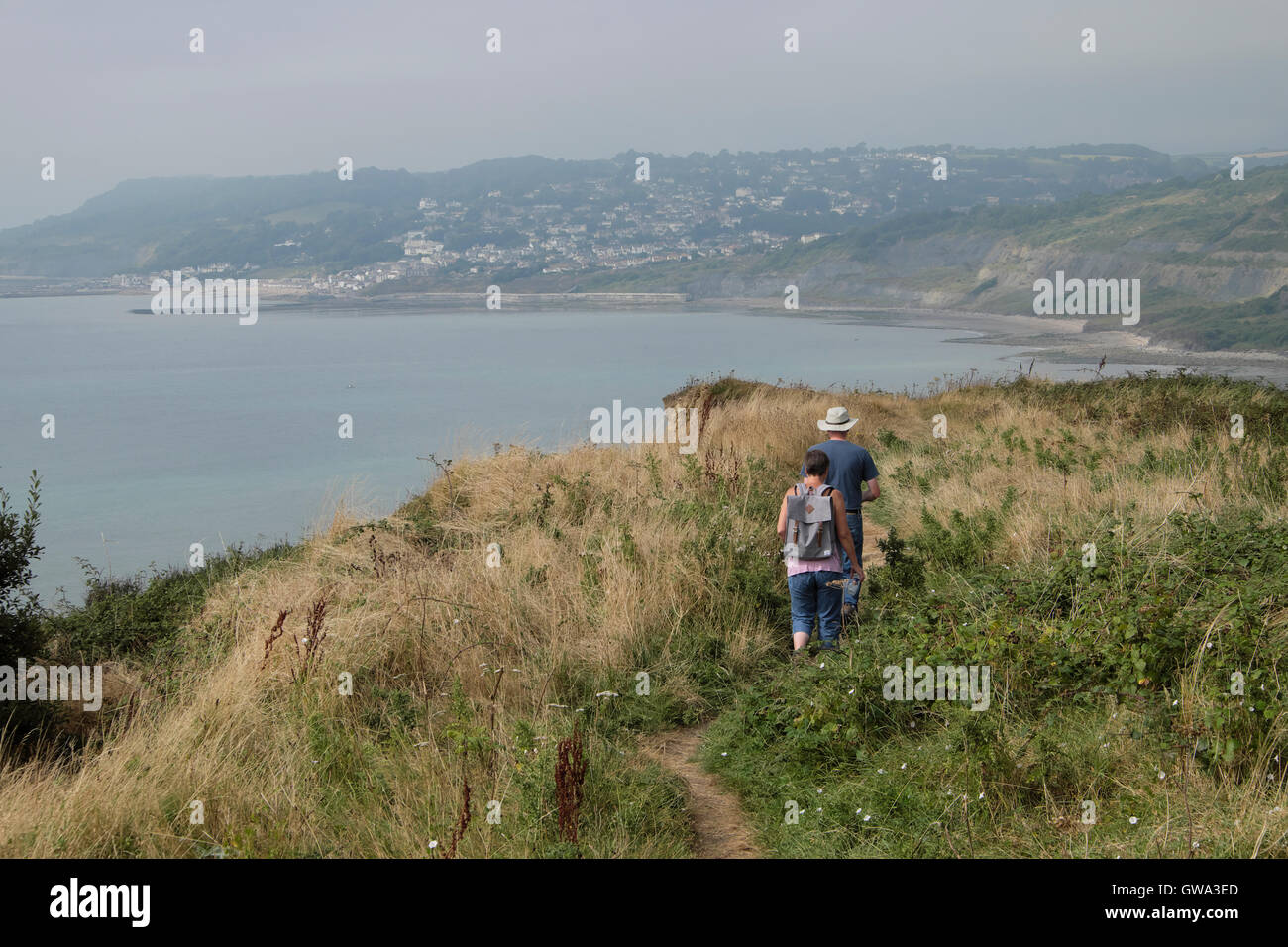 People walking along the coastal path near Lyme Regis and Charmouth Dorset UK  KATHY DEWITT Stock Photo