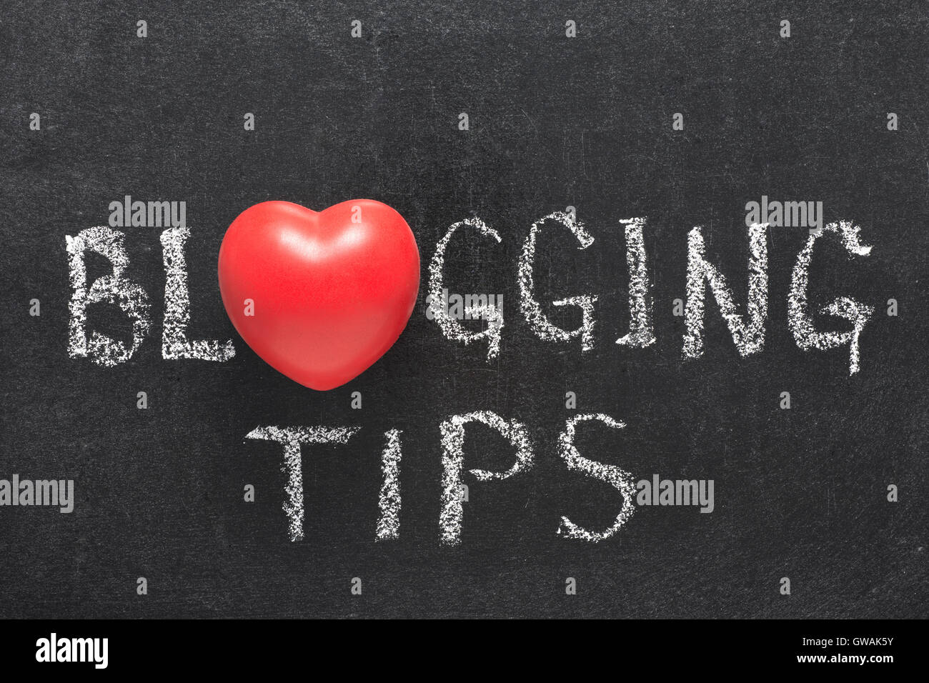 blogging tips phrase handwritten on blackboard with heart symbol instead of O Stock Photo