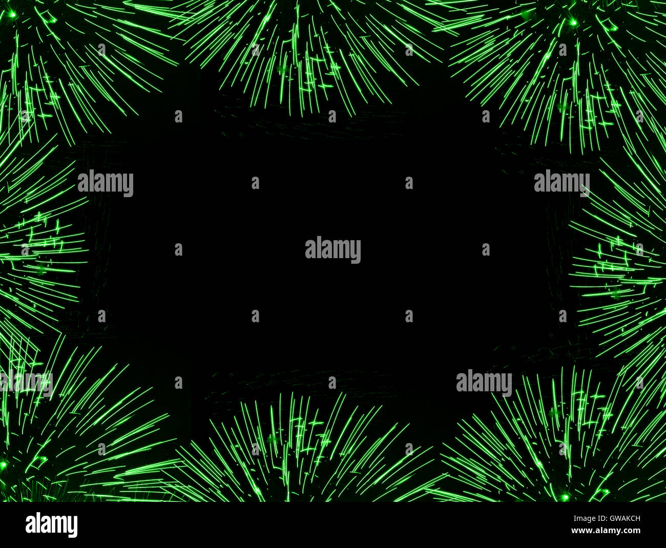 Frame (border) composed of green firework flares isolated on black background with empty copyspace in the middle Stock Photo