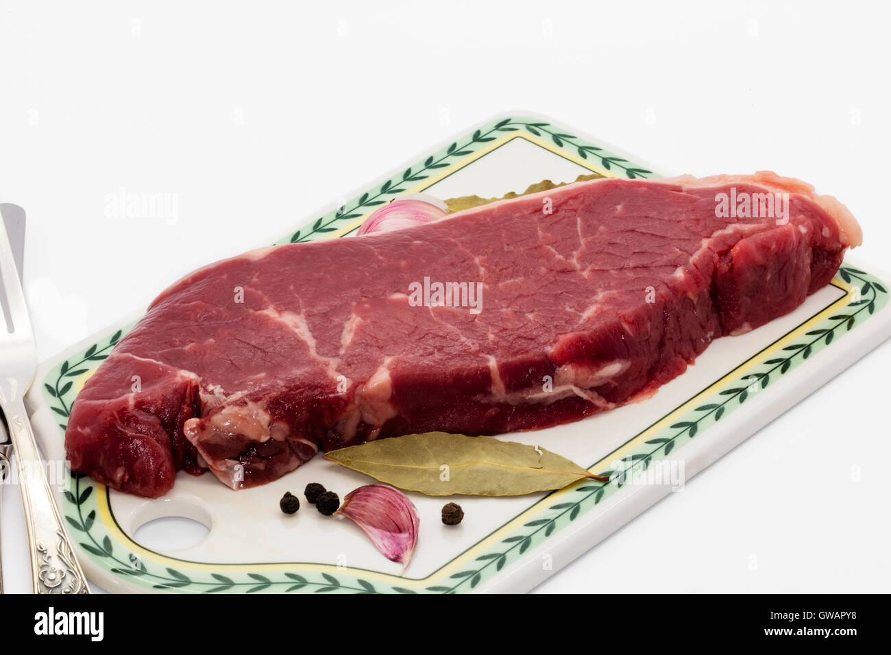 Sirloin steak on a ceramic board. Stock Photo