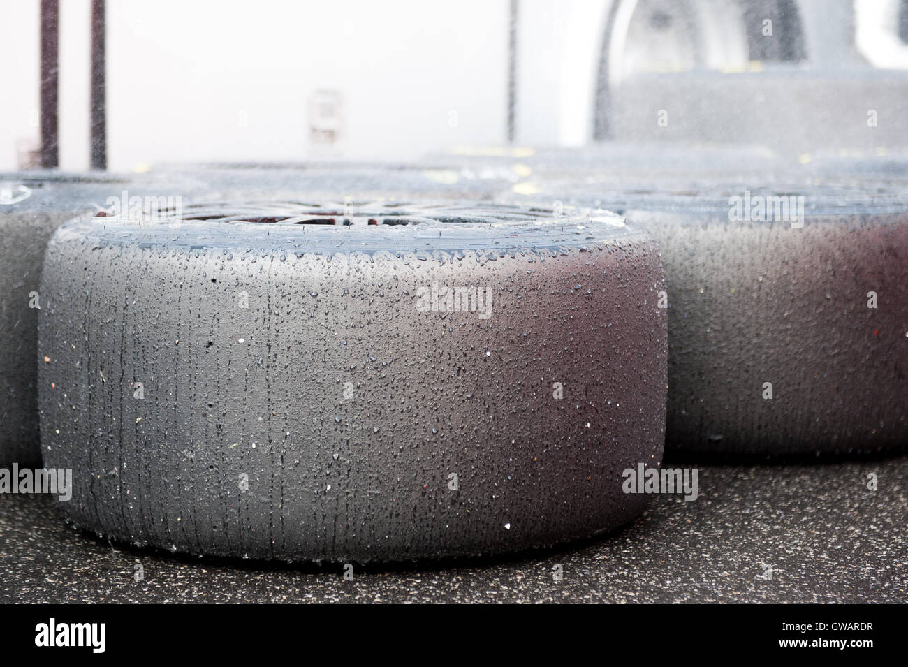 Slick racing tire set refreshment with water wet in pit detail Stock Photo